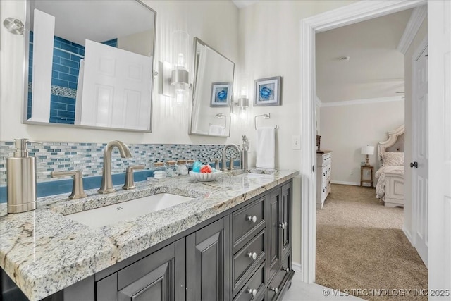 ensuite bathroom featuring crown molding, a sink, ensuite bath, and double vanity