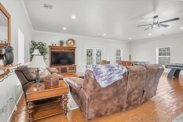 living room featuring recessed lighting, ceiling fan, ornamental molding, and light wood-type flooring