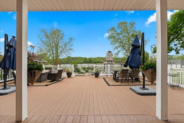 wooden terrace with outdoor dining area