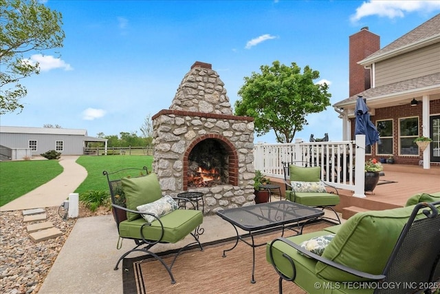 view of patio / terrace featuring an outdoor living space with a fireplace and a deck
