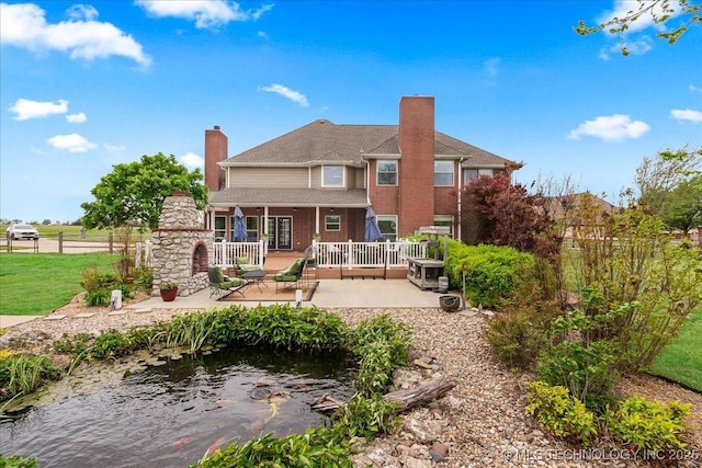 rear view of property with a patio area, fence, a chimney, and a deck