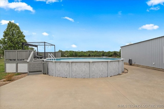 outdoor pool with a wooden deck
