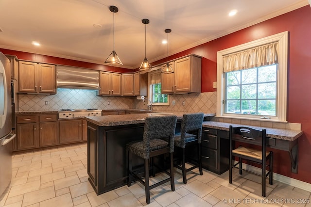 3505 S Birmingham Ave, Tulsa, OK 74105 - kitchen featuring custom range hood, dark countertops, a peninsula, stainless steel gas cooktop, and backsplash