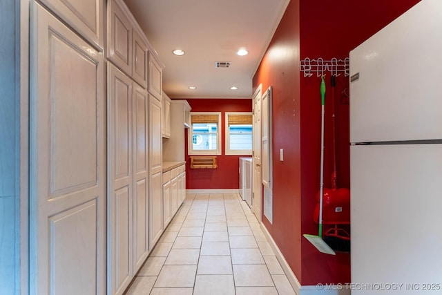 3505 S Birmingham Ave, Tulsa, OK 74105 - hallway featuring light tile patterned floors, recessed lighting, and washing machine and clothes dryer