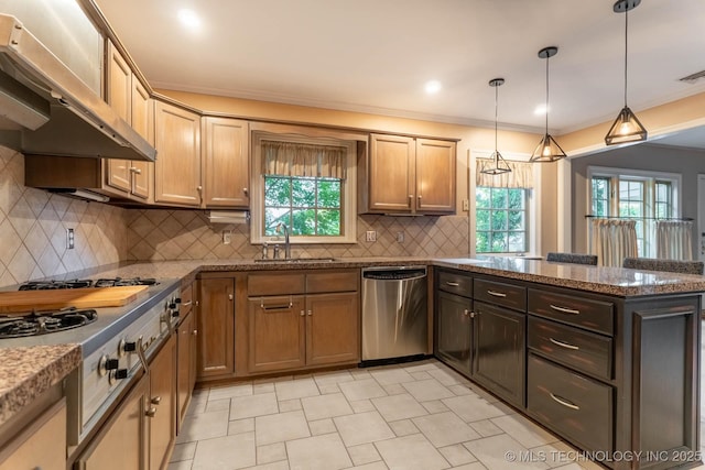 3505 S Birmingham Ave, Tulsa, OK 74105 - kitchen with stainless steel appliances, exhaust hood, a peninsula, dark stone counters, and hanging light fixtures