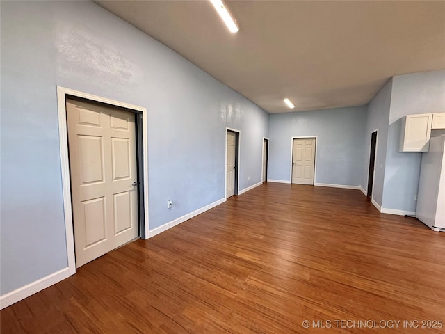 unfurnished room featuring baseboards and wood finished floors