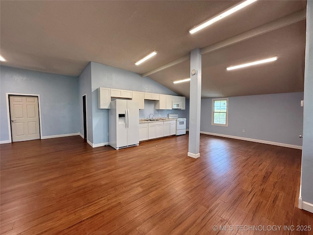 unfurnished living room featuring baseboards, vaulted ceiling with beams, and dark wood-style floors