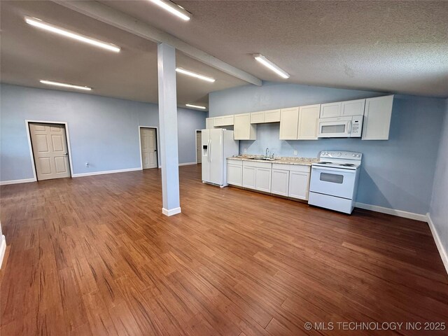 kitchen with a sink, white appliances, and wood finished floors