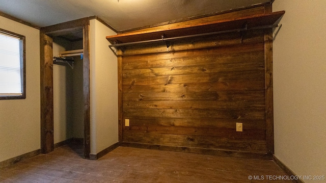 spacious closet featuring dark wood finished floors