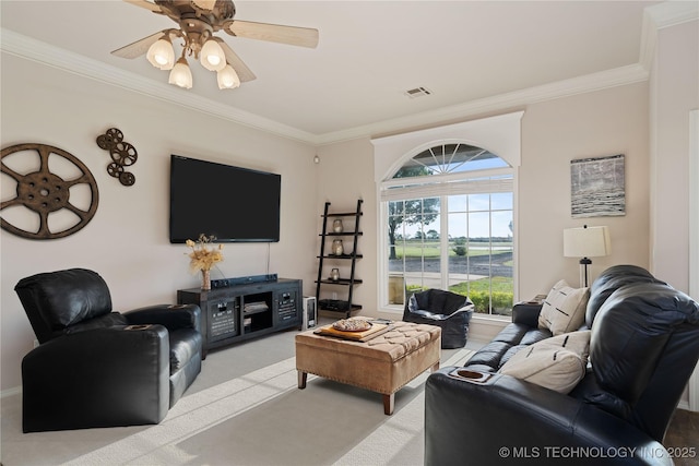 living room featuring crown molding, a ceiling fan, visible vents, and light carpet