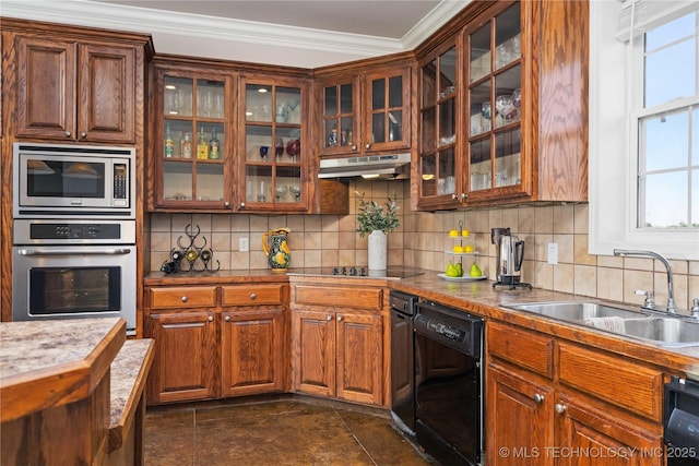 kitchen featuring a sink, under cabinet range hood, glass insert cabinets, black appliances, and ornamental molding