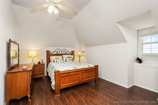 bedroom featuring baseboards, a ceiling fan, dark wood-style flooring, and vaulted ceiling