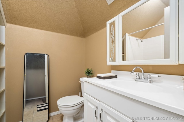 bathroom with tile patterned floors, vanity, toilet, and vaulted ceiling