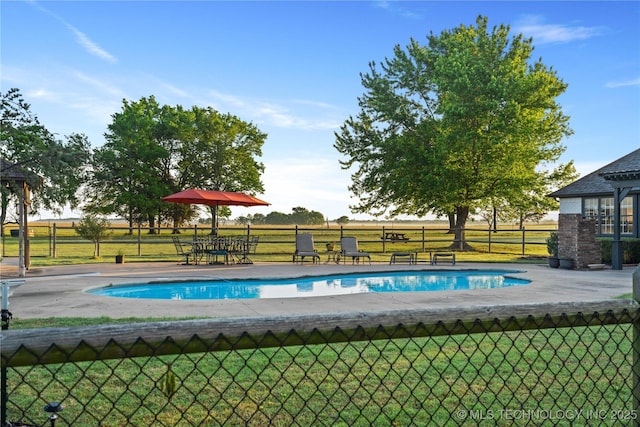 view of swimming pool with fence, a yard, and a fenced in pool