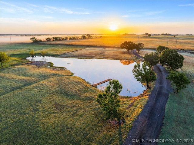 aerial view at dusk with a water view