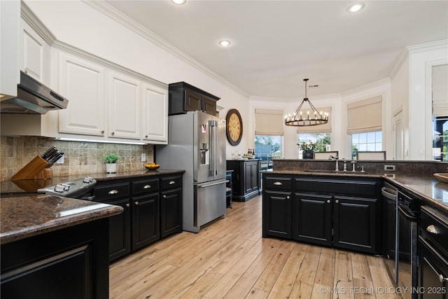 kitchen featuring white cabinets, dark cabinets, a sink, under cabinet range hood, and stainless steel fridge with ice dispenser