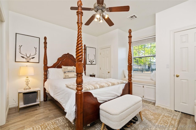 bedroom with baseboards, visible vents, ceiling fan, and light wood-style floors