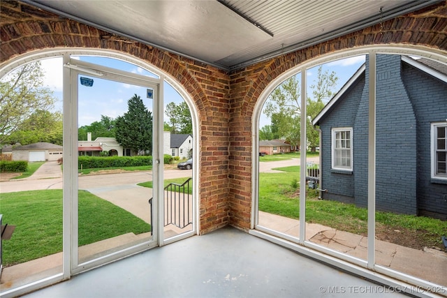1212 S Knoxville Ave, Tulsa, OK 74112 - entryway with brick wall and finished concrete floors