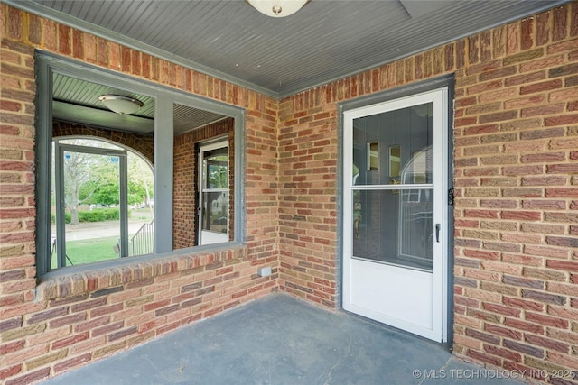 1212 S Knoxville Ave, Tulsa, OK 74112 - doorway to property featuring covered porch and brick siding