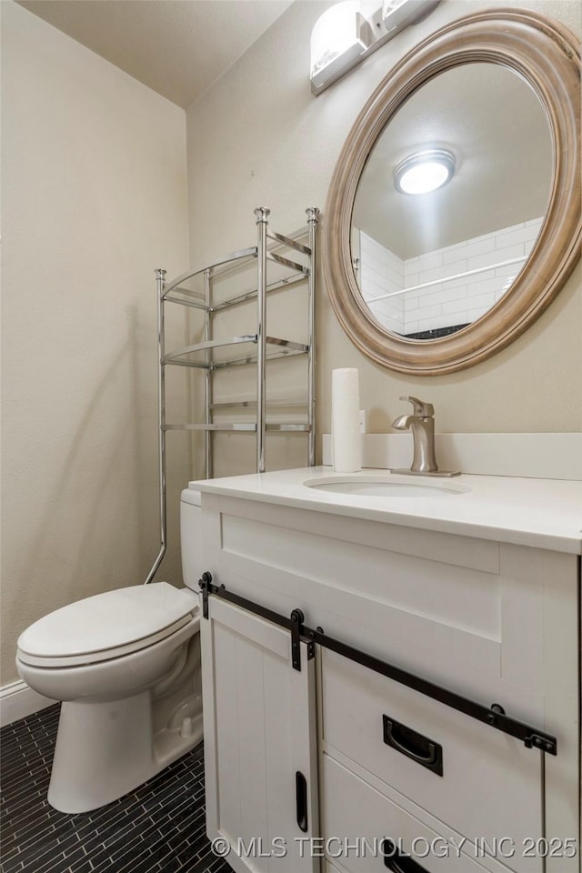 1212 S Knoxville Ave, Tulsa, OK 74112 - bathroom featuring toilet, tile patterned flooring, and vanity
