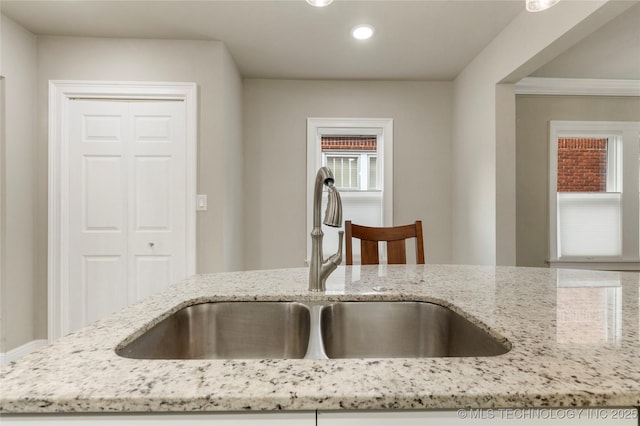 1212 S Knoxville Ave, Tulsa, OK 74112 - kitchen featuring light stone countertops, recessed lighting, and a sink