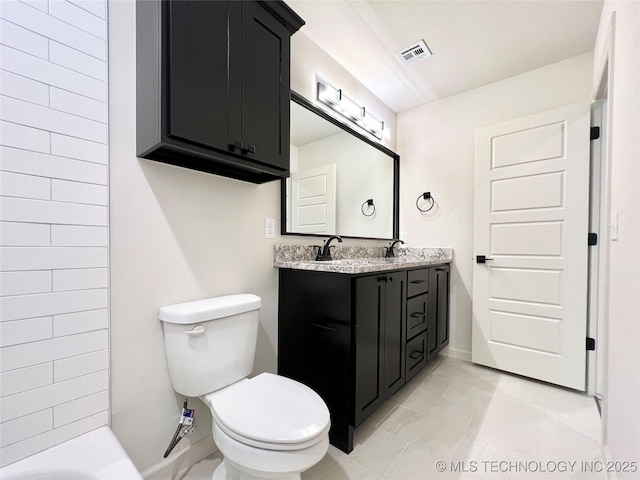 full bathroom with visible vents, toilet, double vanity, and a sink