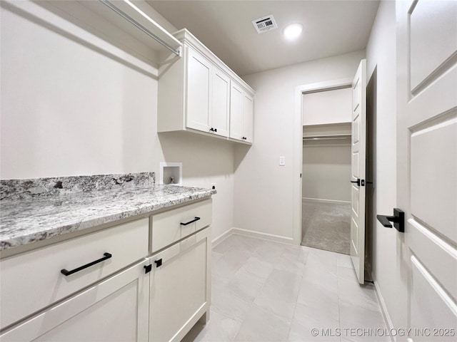 washroom featuring washer hookup, visible vents, baseboards, recessed lighting, and cabinet space