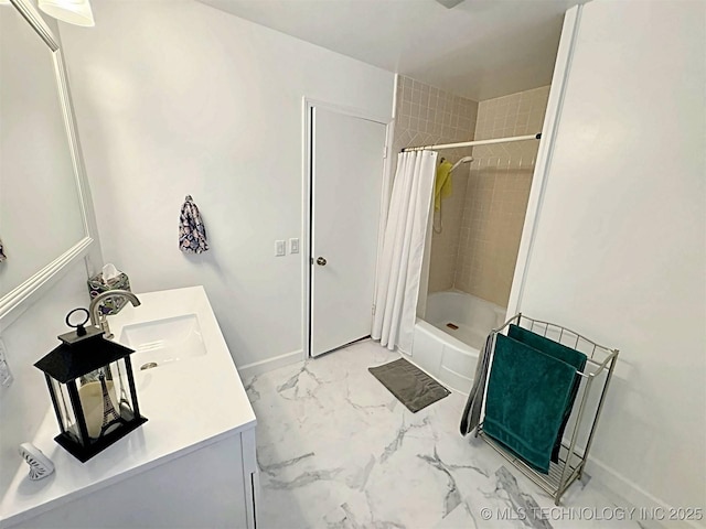 bathroom featuring baseboards, shower / bath combination with curtain, marble finish floor, and vanity