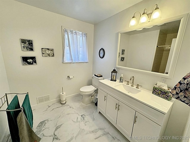 bathroom featuring visible vents, vanity, marble finish floor, toilet, and baseboards