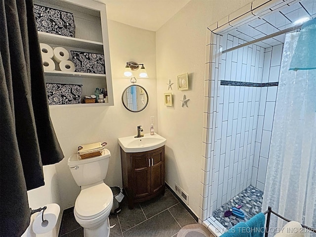full bathroom with tile patterned flooring, visible vents, vanity, toilet, and a stall shower