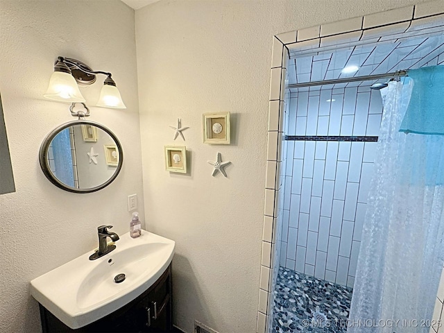 bathroom featuring vanity and a tile shower