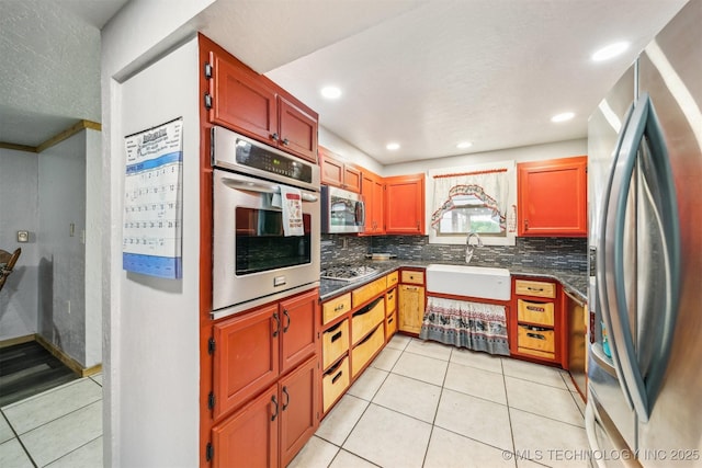 kitchen featuring a sink, appliances with stainless steel finishes, light tile patterned flooring, recessed lighting, and backsplash
