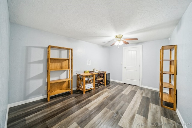 interior space with baseboards, wood finished floors, a ceiling fan, and a textured ceiling
