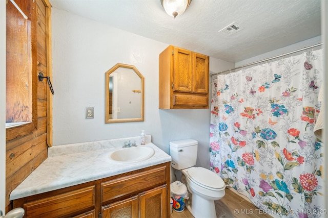 full bath featuring vanity, toilet, visible vents, wood finished floors, and a shower with shower curtain
