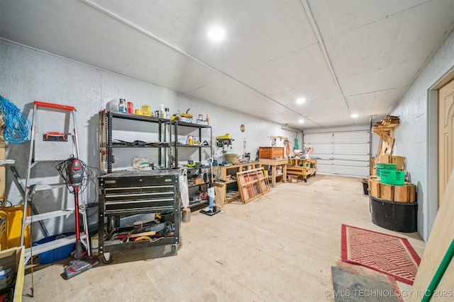 garage with a workshop area and recessed lighting