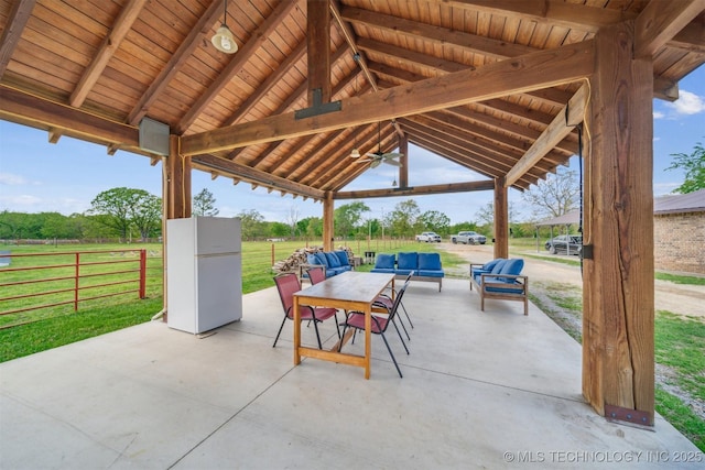 view of patio with fence, a gazebo, ceiling fan, and an outdoor hangout area