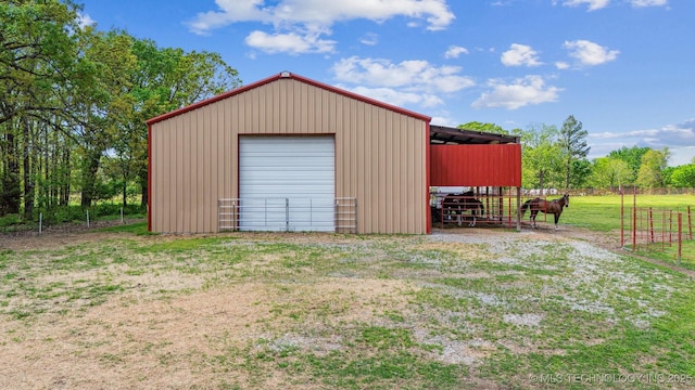 view of outbuilding featuring an outbuilding and fence