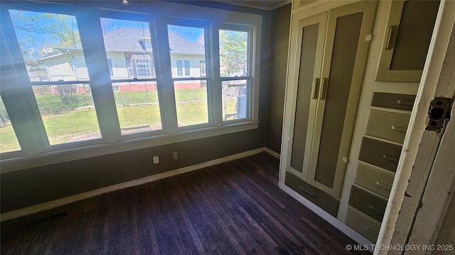 unfurnished sunroom featuring visible vents
