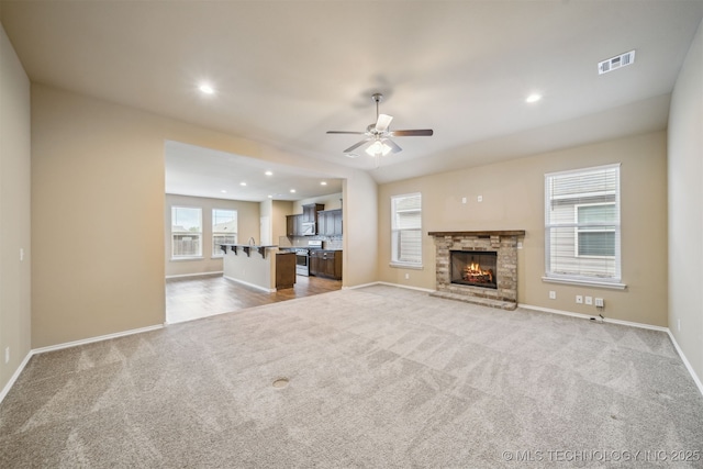 12314 N 131st E Ave, Collinsville, OK 74021 - unfurnished living room with carpet floors, a ceiling fan, baseboards, recessed lighting, and a brick fireplace