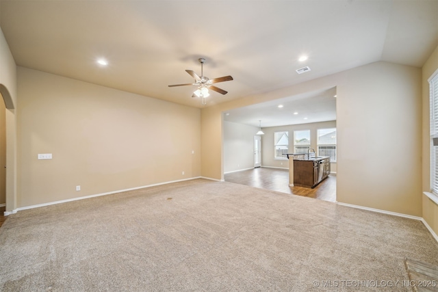 12314 N 131st E Ave, Collinsville, OK 74021 - unfurnished living room featuring carpet floors, a ceiling fan, recessed lighting, baseboards, and arched walkways
