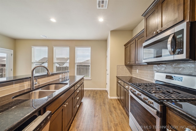 12314 N 131st E Ave, Collinsville, OK 74021 - kitchen with appliances with stainless steel finishes, baseboards, dark stone countertops, and recessed lighting
