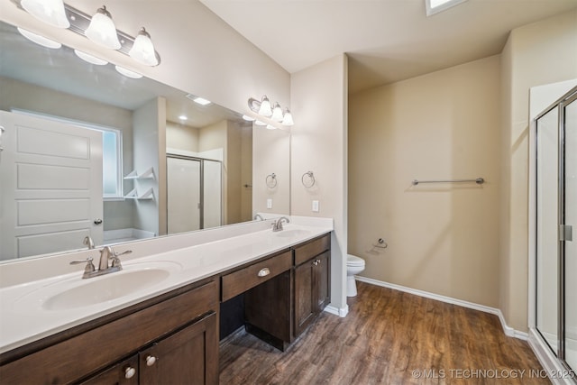12314 N 131st E Ave, Collinsville, OK 74021 - bathroom with a shower stall, baseboards, double vanity, wood finished floors, and toilet