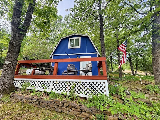 rear view of property with a wooden deck