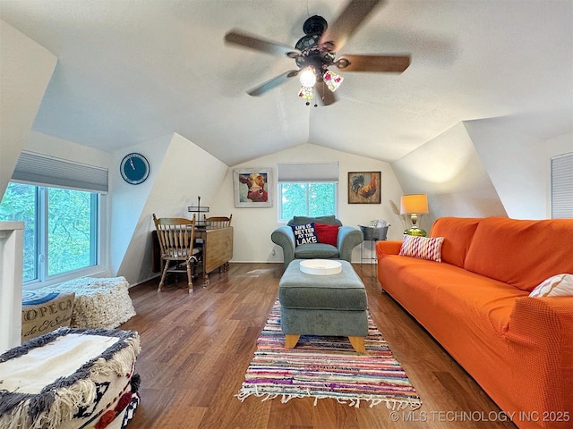 living area featuring lofted ceiling, a textured ceiling, wood finished floors, and a ceiling fan
