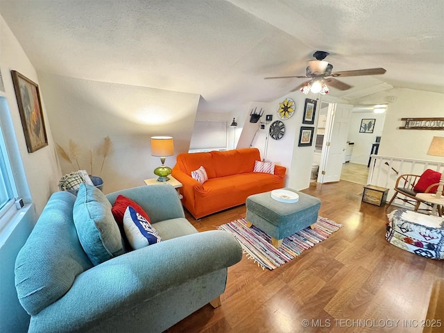 living room featuring wood finished floors, ceiling fan, a textured ceiling, and vaulted ceiling