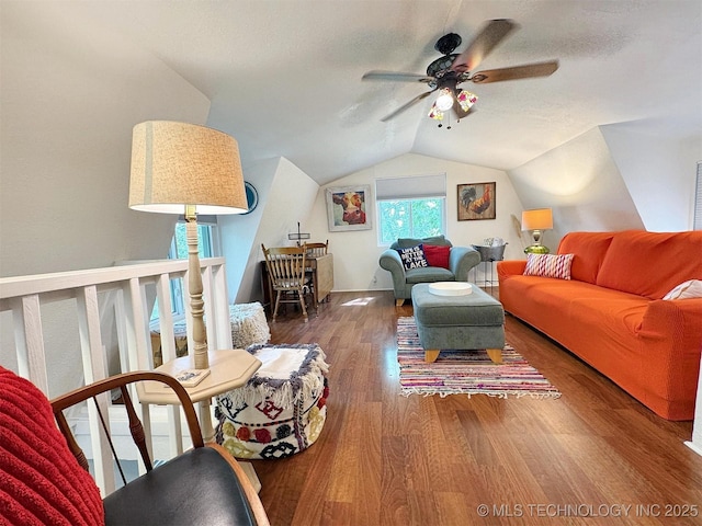 living room featuring a ceiling fan, wood finished floors, and lofted ceiling