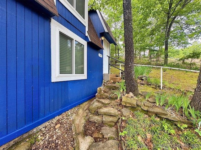 view of side of home with fence