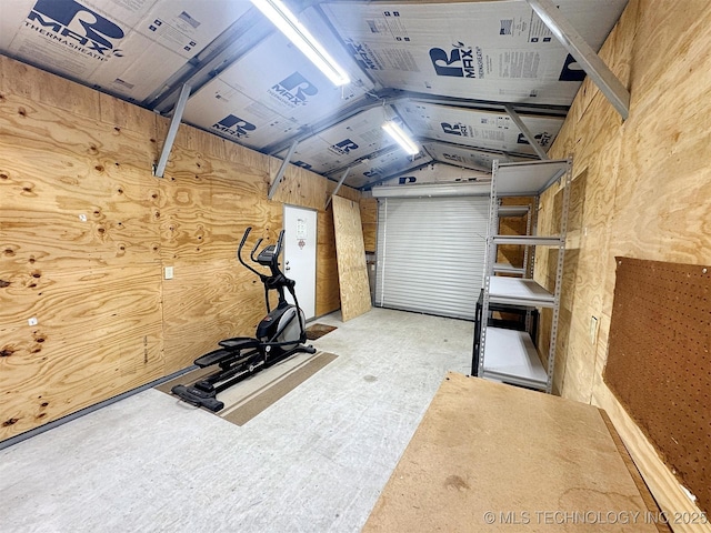 exercise room featuring vaulted ceiling