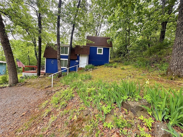 view of front of property featuring a storage unit and an outbuilding