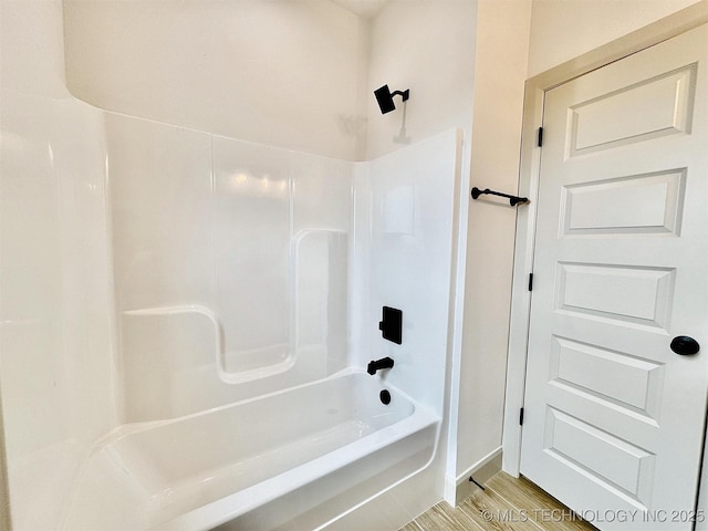 bathroom featuring shower / tub combination and wood finished floors